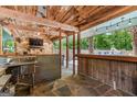 Entertainer's dream outdoor bar area with sink, countertop, seating, and view of the pool and outdoor living space at 3313 Henson Ln, Stockbridge, GA 30281