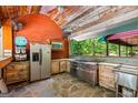 Rustic outdoor kitchen featuring stainless steel appliances, a large gas range, and a stone floor at 3313 Henson Ln, Stockbridge, GA 30281