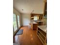 Bright kitchen with wood floors, an island, pendant lighting, and direct access to the outdoors at 201 Summerford Pl, Stockbridge, GA 30281