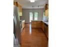 Open kitchen with stainless steel appliances, quartz countertops, wood floors, and ample cabinet space at 201 Summerford Pl, Stockbridge, GA 30281