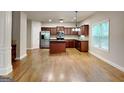 Open-concept kitchen area with wood floors, stainless appliances and ample counter space at 330 Bentleigh Station Dr, Acworth, GA 30101