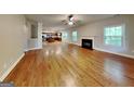 Expansive living room features hardwood floors, a fireplace, and abundant natural light at 330 Bentleigh Station Dr, Acworth, GA 30101