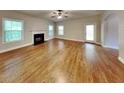 Inviting living space with a fireplace, hardwood floors, large windows, and great natural light, creating a comfortable ambiance at 330 Bentleigh Station Dr, Acworth, GA 30101