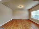 Bright living area with hardwood floors, neutral walls, and large windows for ample natural light at 330 Bentleigh Station Dr, Acworth, GA 30101