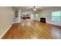 Open living area with hardwood floors, a fireplace, and seamless flow to kitchen at 330 Bentleigh Station Dr, Acworth, GA 30101