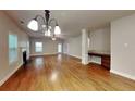Open-concept living room with hardwood floors, fireplace, and ample natural light for a warm and inviting atmosphere at 330 Bentleigh Station Dr, Acworth, GA 30101