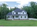 Traditional two-story home with a stone accent and a well-maintained lawn at 214 Wet Wood Ct # 26, Fairburn, GA 30213