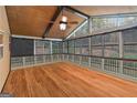 Sunroom showcasing hardwood floors, paneled walls, and multiple windows that offer scenic outdoor views at 2390 Colchester Ct, Cumming, GA 30041