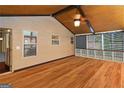 Enclosed sunroom featuring wood floors and paneled walls, providing a tranquil space for relaxation and enjoyment at 2390 Colchester Ct, Cumming, GA 30041