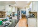 Well-equipped kitchen with black appliances, wood flooring, and a peninsula at 2201 Valley Creek Cir, Snellville, GA 30078