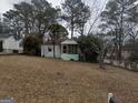 Charming single-story home with a welcoming screened front porch and a yard covered in fallen leaves at 2010 Mcafee Pl, Decatur, GA 30032