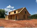 New two-story home under construction shows exposed framework and covered front porch at 242 Old Jackson Rd, Mcdonough, GA 30252