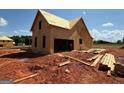 New home under construction shows exposed framework and a large opening for a garage at 242 Old Jackson Rd, Mcdonough, GA 30252