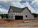 New construction home with garage and a gabled roof, plus windows already installed at 242 Old Jackson Rd, Mcdonough, GA 30252
