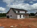 New construction home featuring a gabled roof, covered porch, and many windows at 242 Old Jackson Rd, Mcdonough, GA 30252