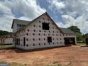 A two-story house under construction featuring unfinished garage and porch framing at 1916 King Mill Rd, Mcdonough, GA 30252