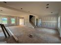 Large open-concept living room featuring an unfinished staircase at 1916 King Mill Rd, Mcdonough, GA 30252