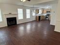 Open-concept living room features a fireplace, bright windows, and views into the kitchen at 6372 Stonebridge Creek Ln, Lithonia, GA 30058