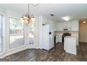 Eat-in kitchen features white cabinets, stainless appliances, and hardwood floors at 421 Old Ivy Path, Mcdonough, GA 30253