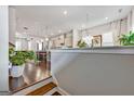 Open-concept living space featuring hardwood floors, modern lighting, and a view into the adjacent gourmet kitchen at 4760 Highside Way, Smyrna, GA 30082