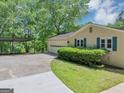 Home featuring a two-car garage, covered parking, and landscaping at 4820 Yeager Rd, Douglasville, GA 30135