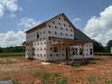 Exterior view displaying the back of the house and covered porch during construction at 1936 King Mill Rd, Mcdonough, GA 30252