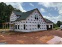 View of house during construction showing back and side with installed windows at 1936 King Mill Rd, Mcdonough, GA 30252