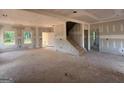 Unfinished living room showcases a spacious layout, natural light, and staircase at 1936 King Mill Rd, Mcdonough, GA 30252