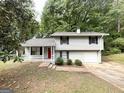 Inviting split-level home with a cozy front porch and a vibrant red front door at 3879 Mcgill Ln, Decatur, GA 30034
