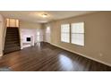 Open-concept living area showcasing wood floors, staircase, and view of the fireplace at 3879 Mcgill Ln, Decatur, GA 30034