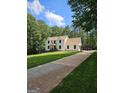 Charming two-story home with long driveway and well-manicured front yard, surrounded by lush trees at 175 Forest Lake Dr, Fayetteville, GA 30215