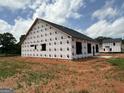 The exterior of the house shows the dark roof and window openings at 1926 King Mill Rd, Mcdonough, GA 30252