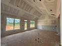 Unfinished living room with large windows offering scenic views and abundant light at 1926 King Mill Rd, Mcdonough, GA 30252