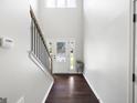 Bright entryway with hardwood floors, a staircase, and a front door with decorative glass at 1016 Buckeye Ln, Villa Rica, GA 30180