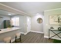 Bright and airy living room featuring hardwood floors, a breakfast bar, and updated finishes for modern living at 1939 Sandringham Sw Dr, Atlanta, GA 30311