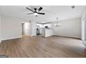 Spacious living area with vinyl floors, a ceiling fan, and open access to the kitchen at 89 Prospect Path, Hiram, GA 30141