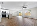 Open-concept layout showcasing the living area with vinyl floors and access to the kitchen at 89 Prospect Path, Hiram, GA 30141