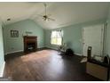 Bright living room featuring a fireplace, high ceilings, and large windows at 150 Doe Run Ct, Sharpsburg, GA 30277