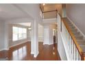 A grand foyer features hardwood floors, staircase, and an open view to adjacent living spaces at 613 Blackburn Ln, Peachtree City, GA 30269