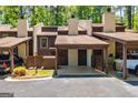 Charming townhouse exterior featuring a covered parking area and well-maintained landscaping at 65 Cobblestone Crk, Peachtree City, GA 30269