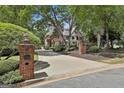 Beautiful brick home with manicured landscaping and a long driveway leading to the residence at 106 Hidden Springs Ln, Peachtree City, GA 30269