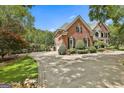 Well-maintained brick home with an expansive driveway and meticulously landscaped grounds at 106 Hidden Springs Ln, Peachtree City, GA 30269