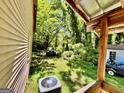 Lush backyard featuring ample space and mature trees, with a glimpse of a shed and vehicle at 585 Huddleston Rd, Fayetteville, GA 30214