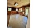 Spacious kitchen with plentiful wood cabinets, ready for customization and updates at 585 Huddleston Rd, Fayetteville, GA 30214