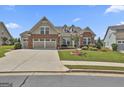 Beautiful single Gathering home with well-kept lawn, brick accents, and a two-car garage at 500 Cottonwood Cir, Peachtree City, GA 30269