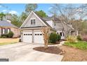 Attached two-car garage and driveway, with a well-maintained lawn, shrubbery and landscaping at 600 Lake Overlook Dr, Canton, GA 30114