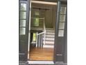 Open entryway showcasing hardwood floors, a staircase with white railings, and natural light at 3132 Riders Trl, Decatur, GA 30034