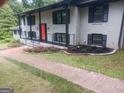 Close up of the exterior showing a brick walkway leading to a bright, updated home at 3132 Riders Trl, Decatur, GA 30034