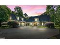 Stately home with an attached two car garage, well manicured landscaping, and a sprawling asphalt driveway at 130 Allie Drive, Mcdonough, GA 30252