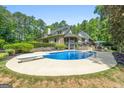 A sparkling blue pool and diving board are the highlights of this home's outdoor entertaining space at 130 Allie Drive, Mcdonough, GA 30252